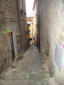 These narrow stairs are far more steep than they appear to be in this photo. Cortona, Italy. 